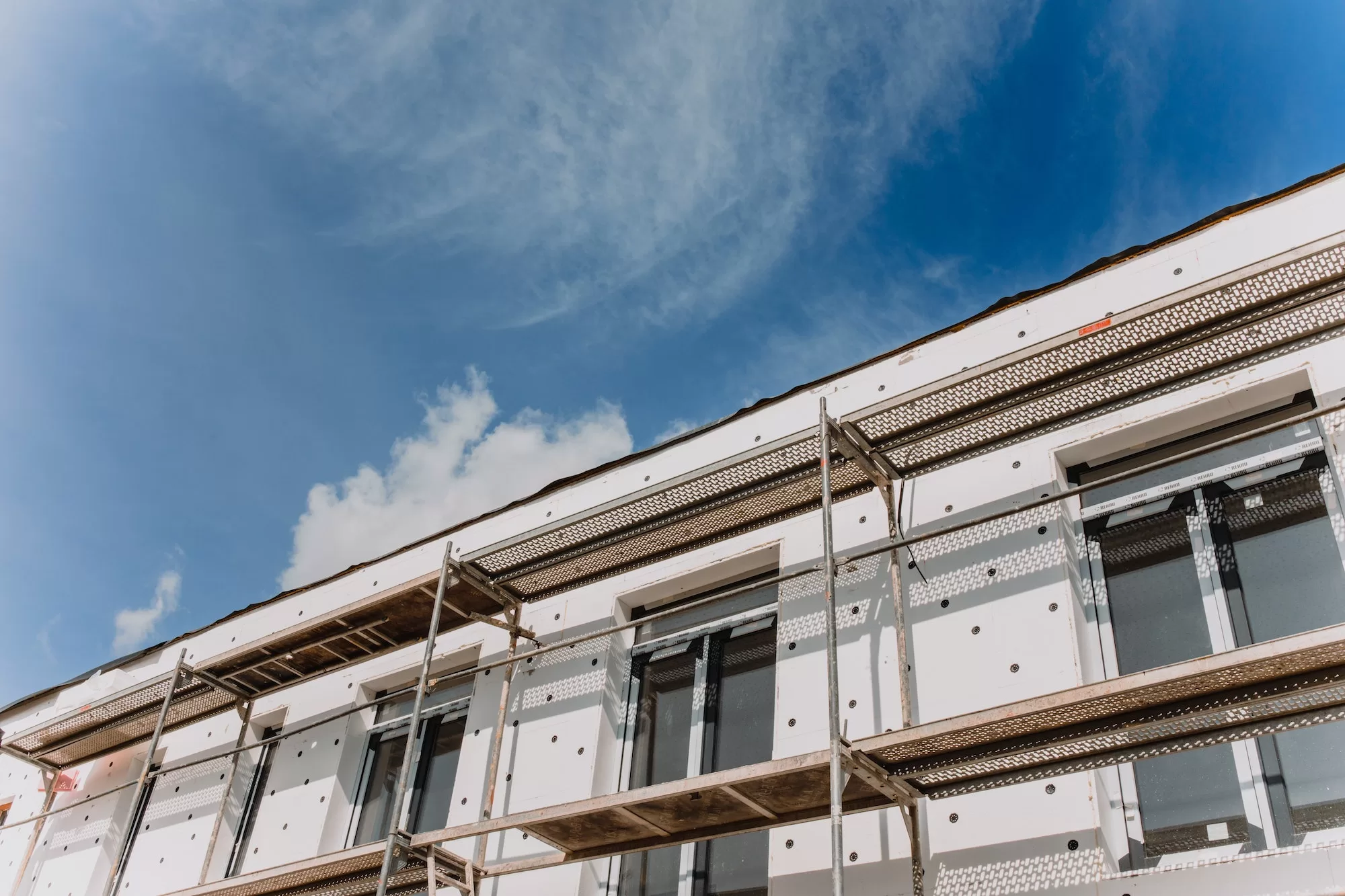 scaffolding on house facade,modern building under construction -